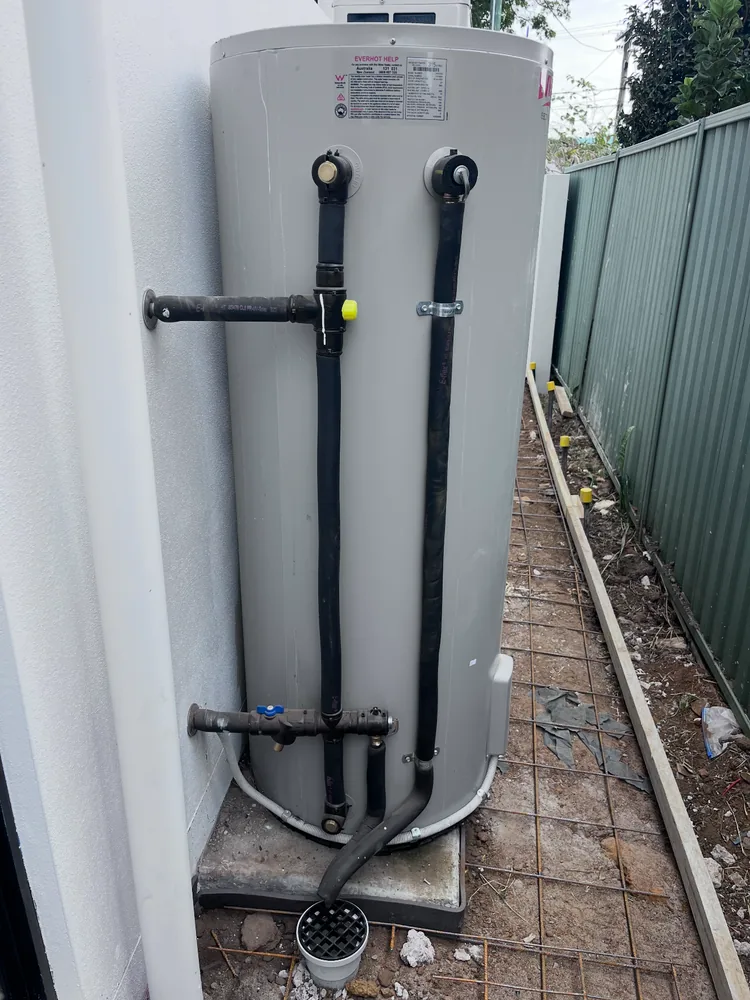 Storage hot water tank installed along the side of a Gold Coast home