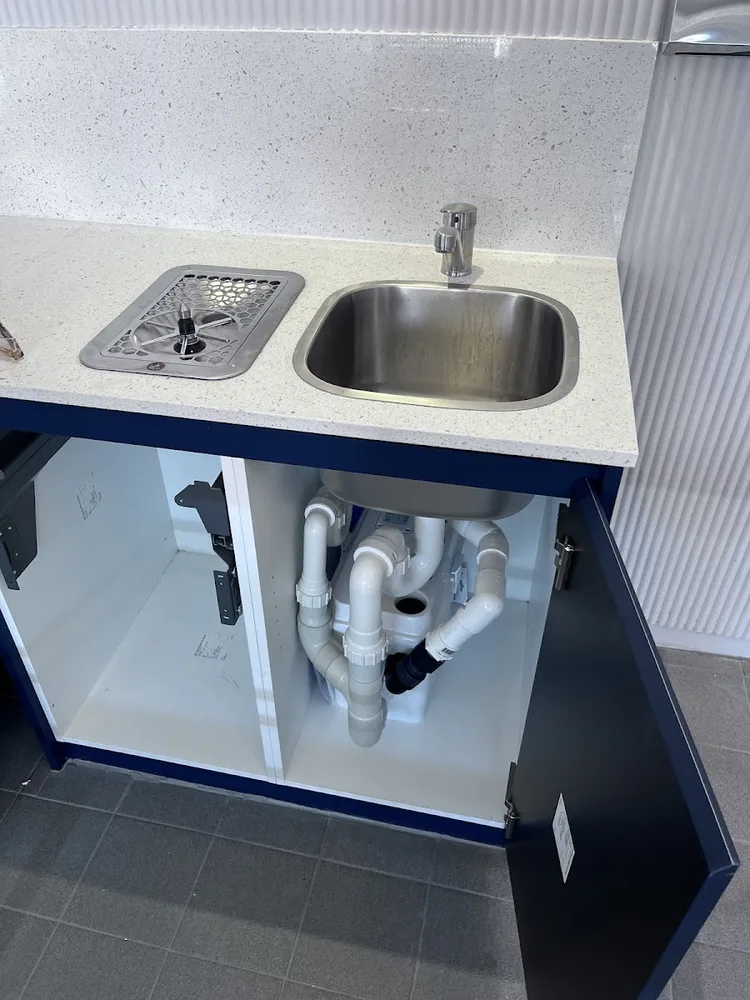 Kitchen sink plumbing opened up for leak inspection and repair