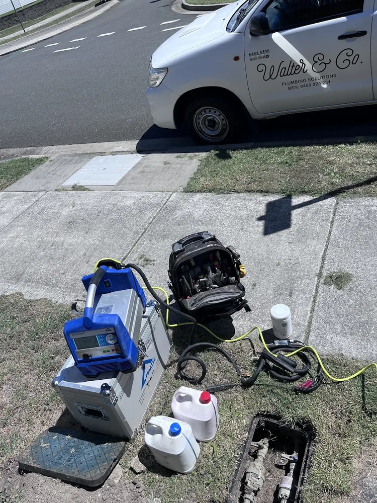 Walter & Co ute on site at a Gold Coast job with the tool kit and equipment laid out on the verge