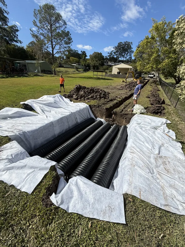 Slotted ag pipe coils ready to lay on the geotextile fabric