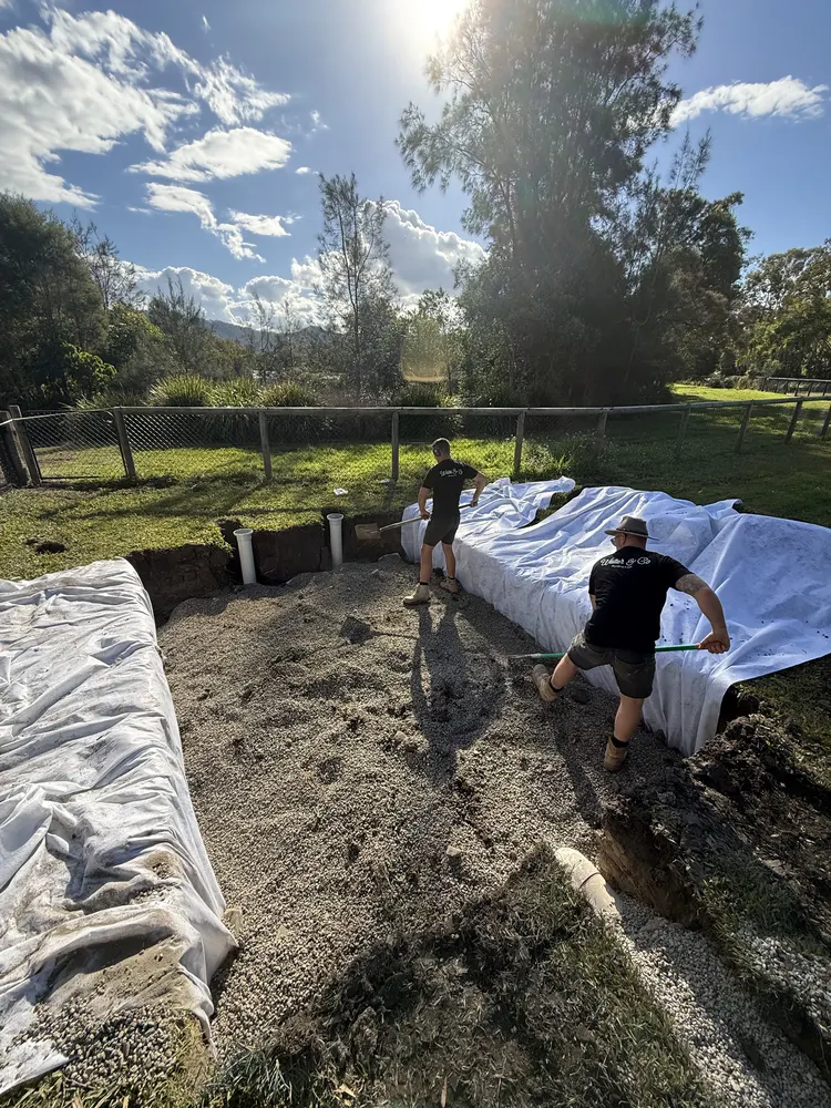 The crew working in the fabric-lined subsoil drainage trench