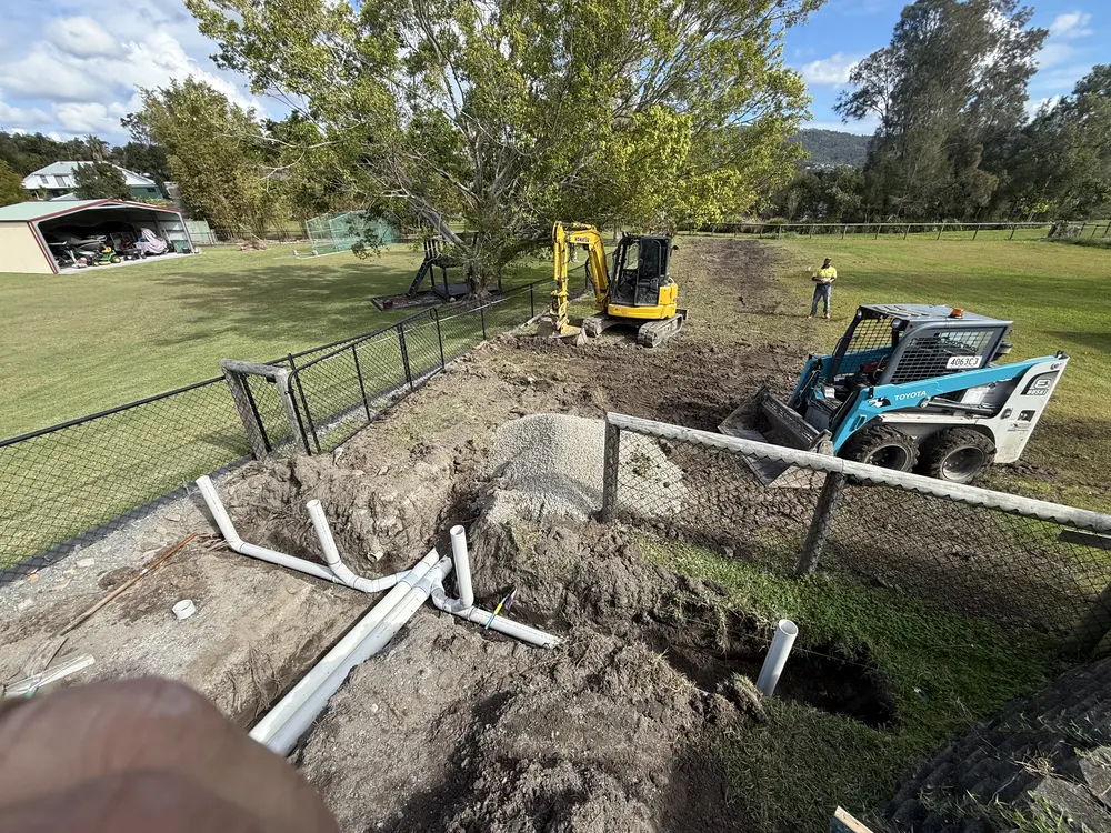 Excavator and bobcat on site for the subsoil drainage install
